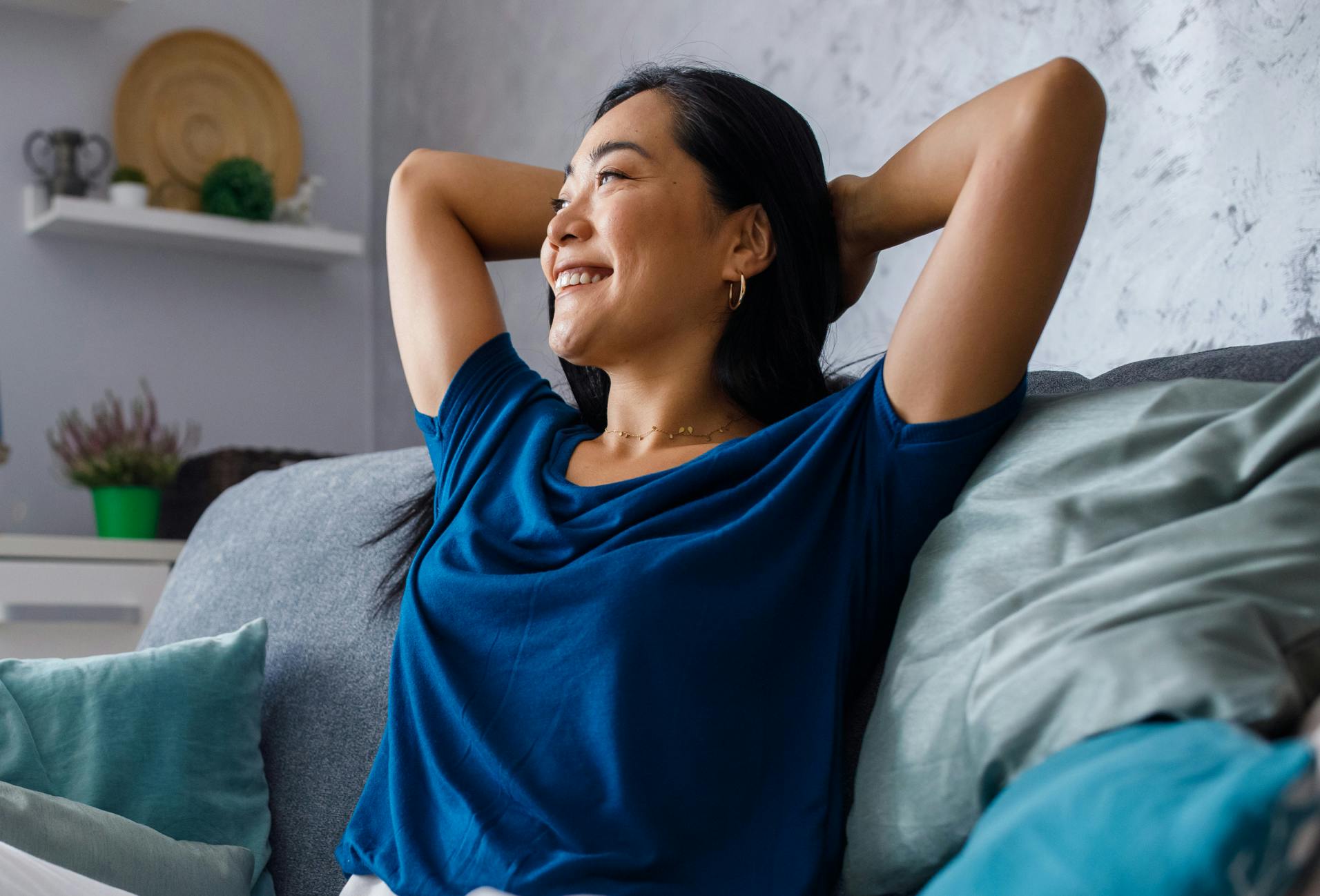 woman smiling and looking relieved on couch