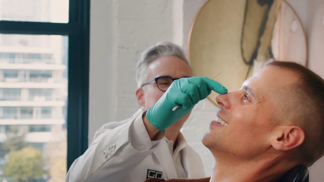 Dr. Moynihan examining patient nose