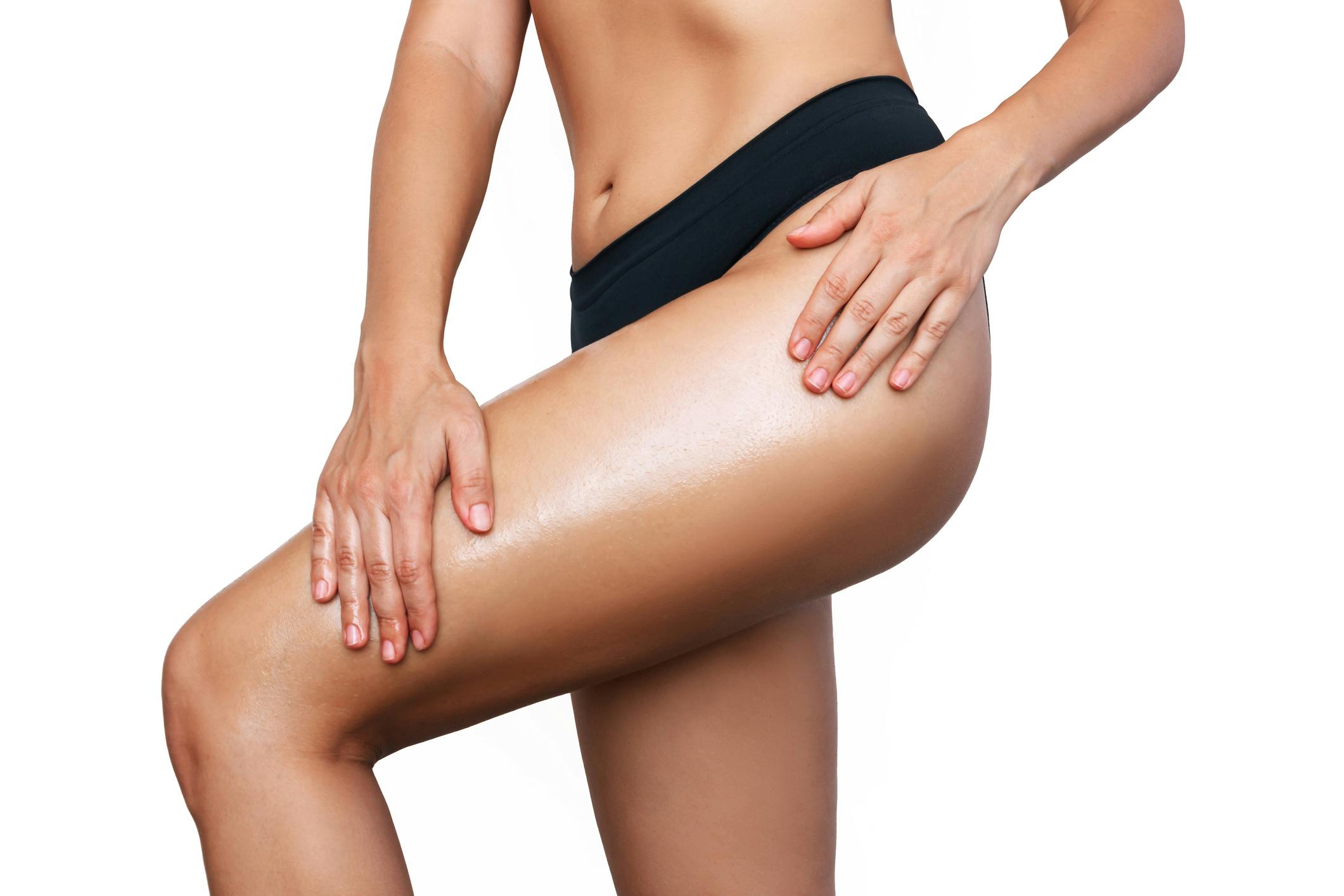 woman in a black bikini holding her butt