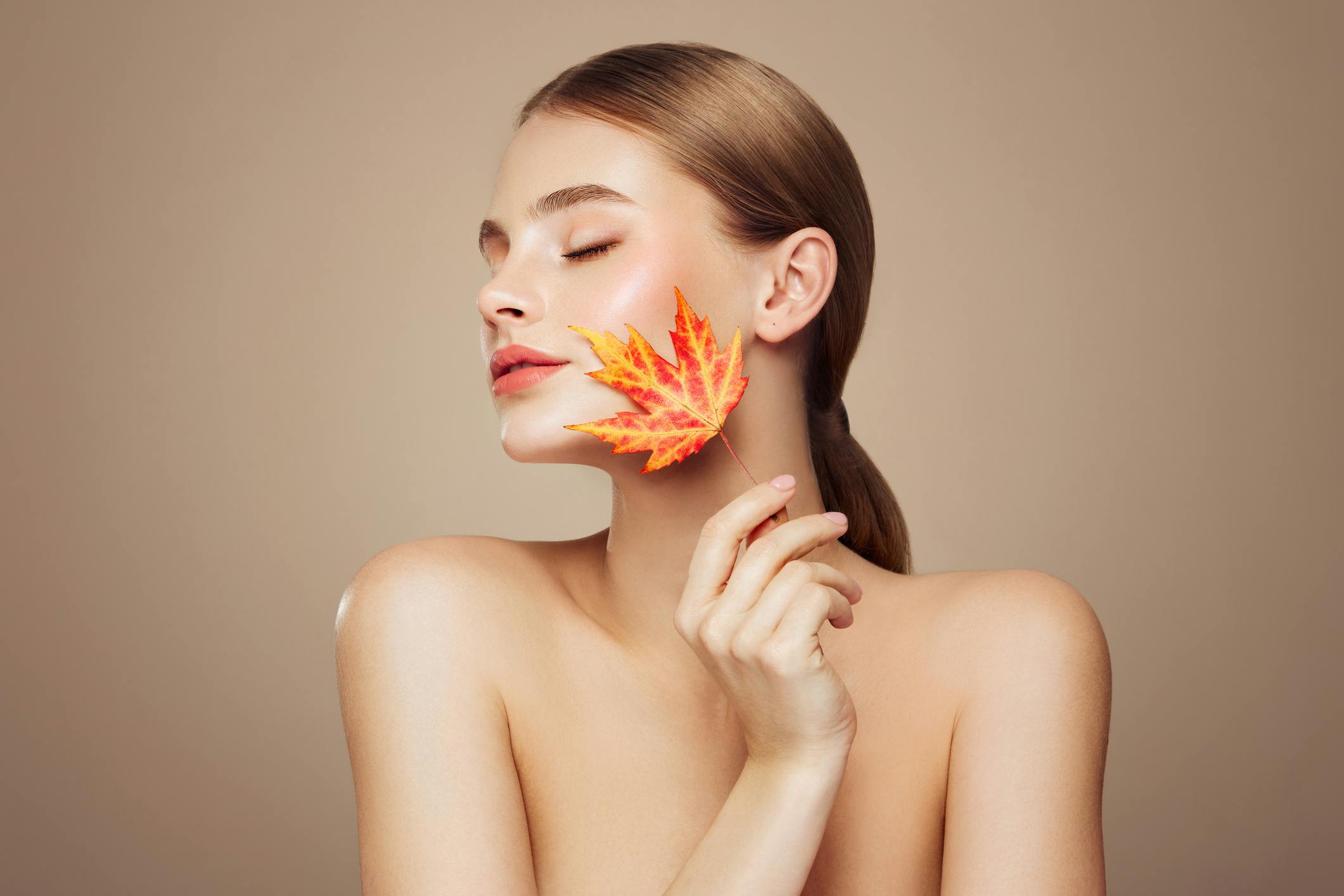 young woman with autumn leaf