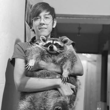 Tim holding racoon