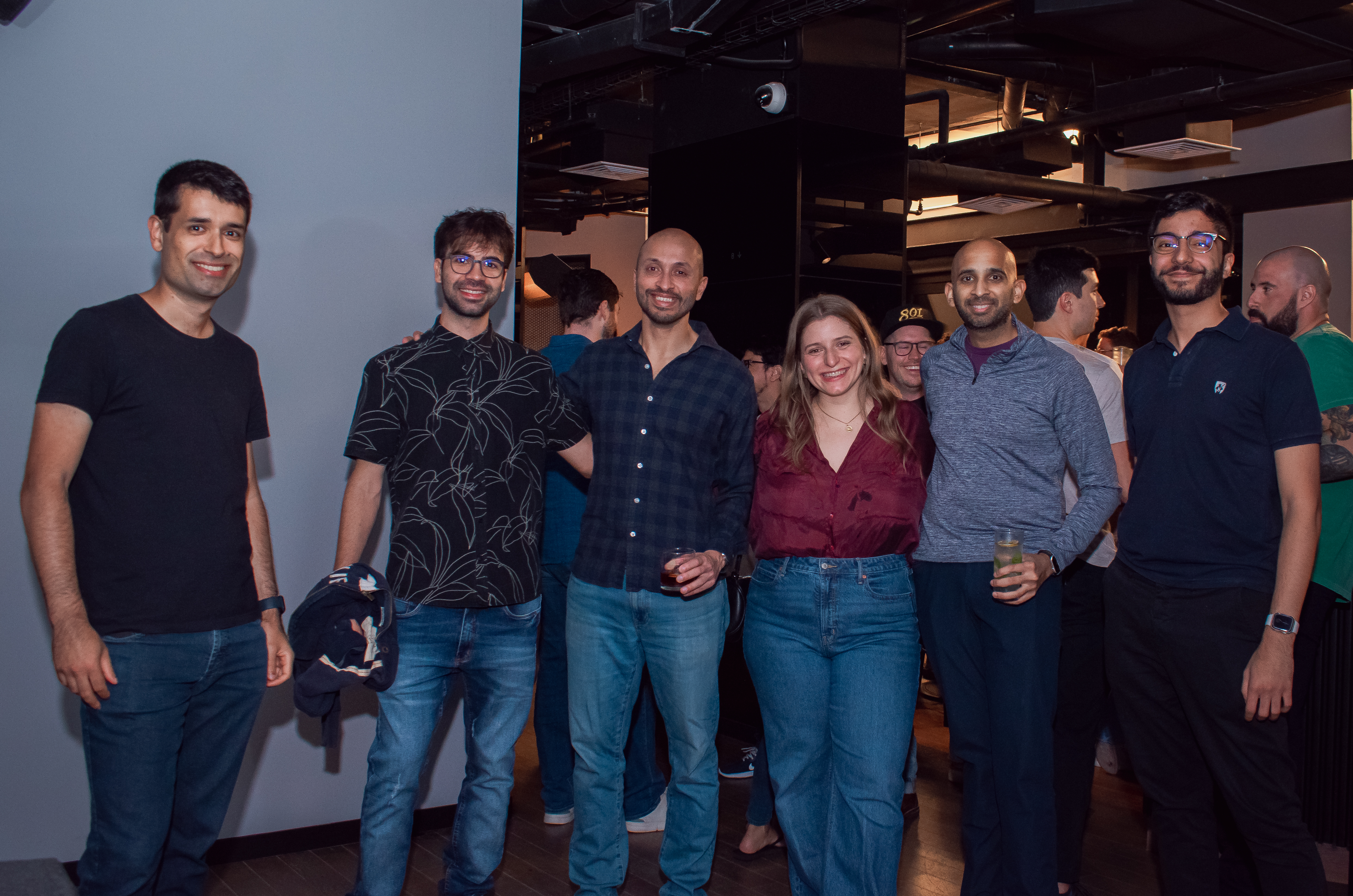 A group of coworkers standing together at a bar.