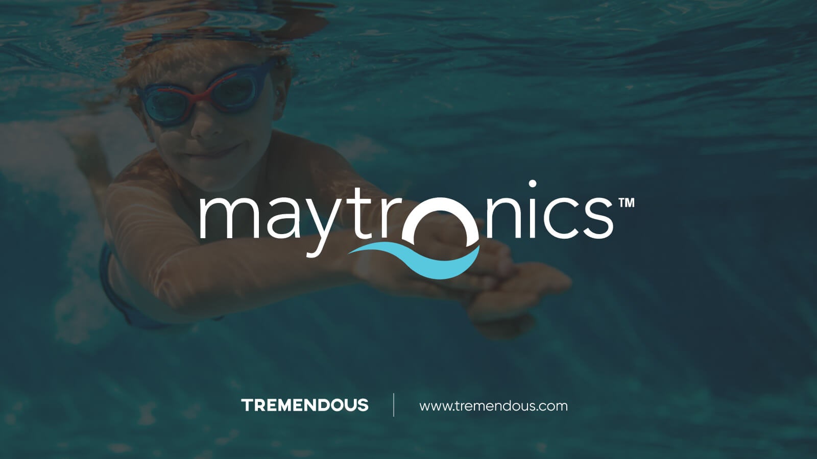 Image of a boy swimming in a pool with the Maytronics logo