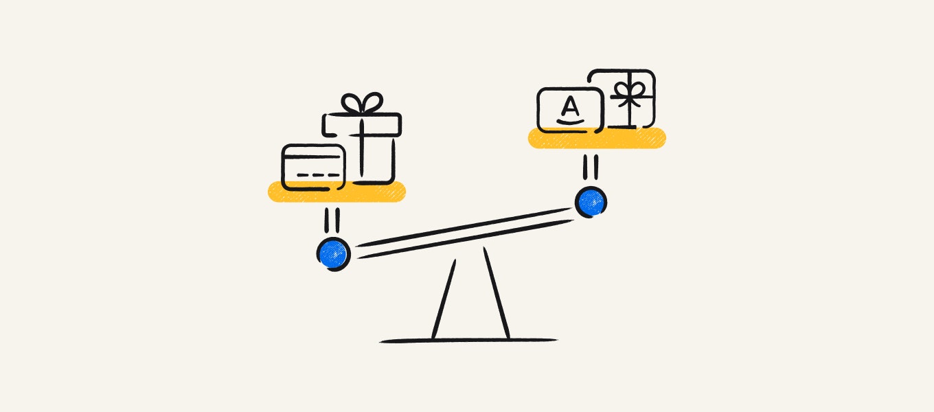 A see-saw with gift Visa cards on one side, and Amazon gift cards on the other.