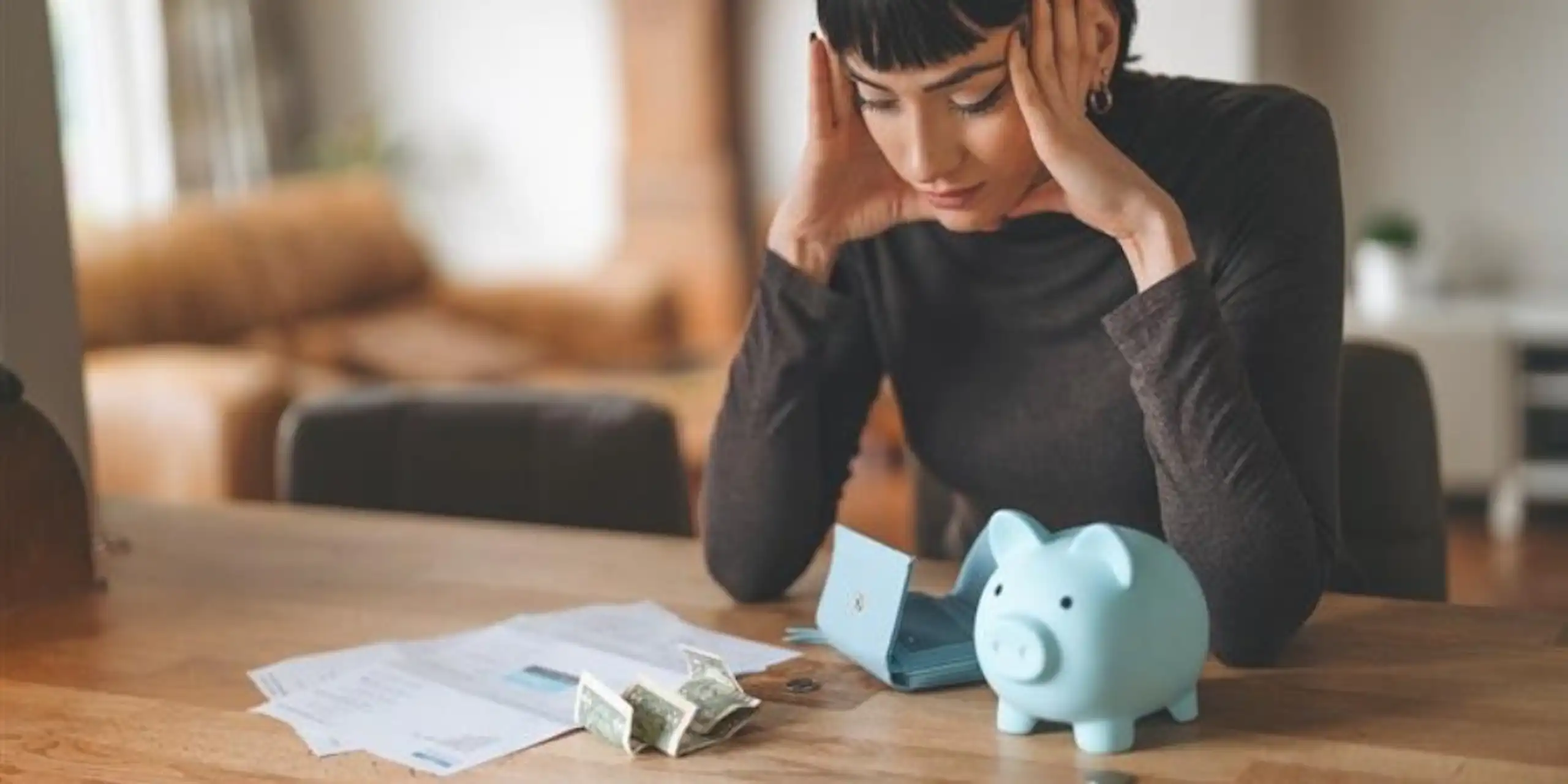 Employee reviewing finances and household expenses at a desk