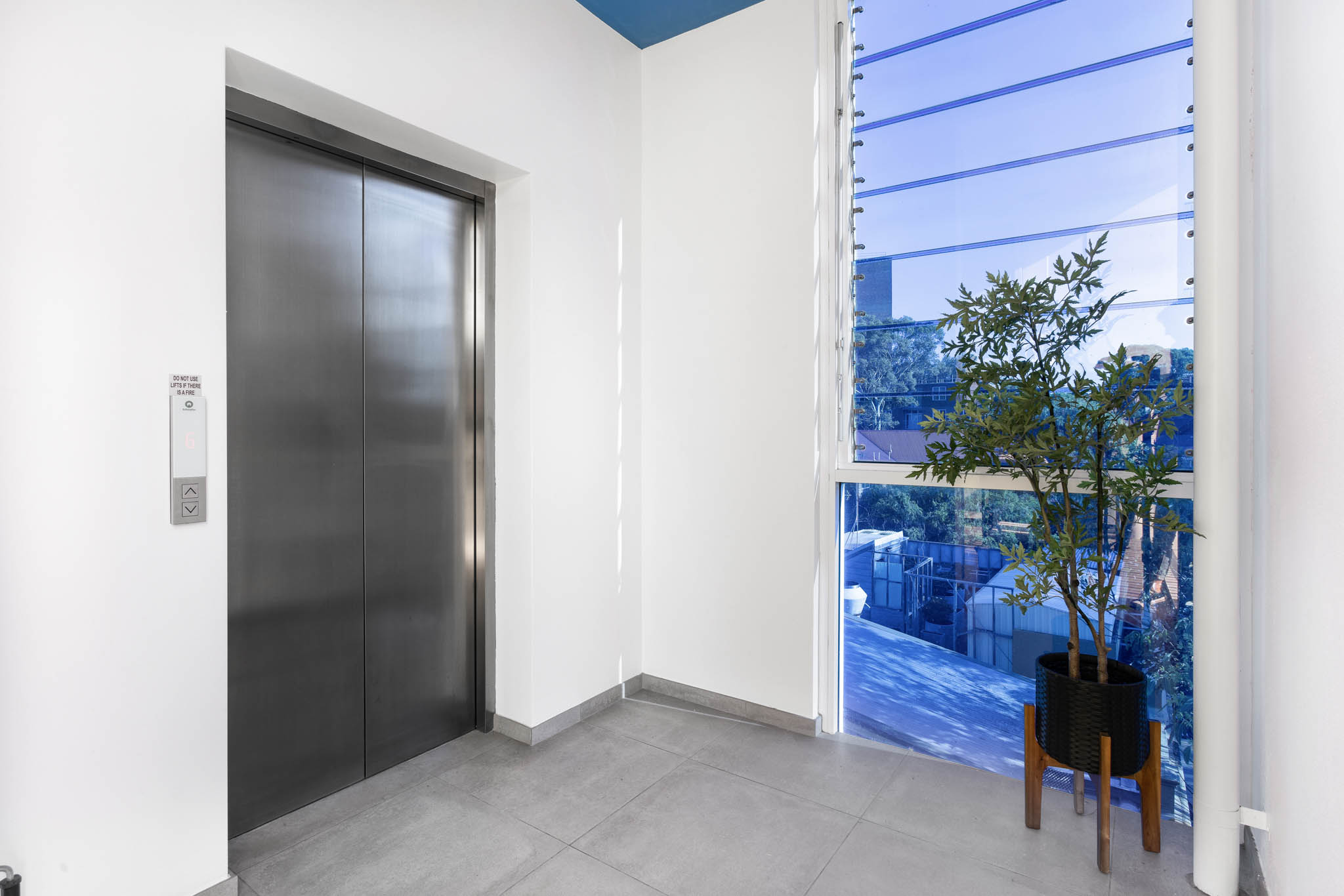 Elevator Entrance Lift Access - One Bedroom Apartment at - The Chromatic Apartments - Urban Rest - Sydney