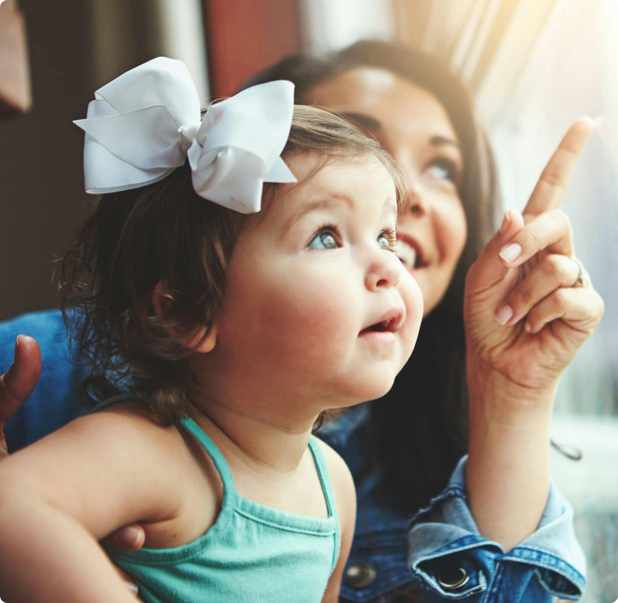 Woman pointing, showing toddler something