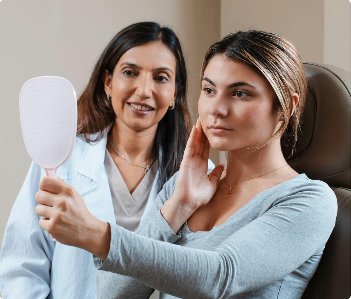 Physician having woman patient look in a mirror