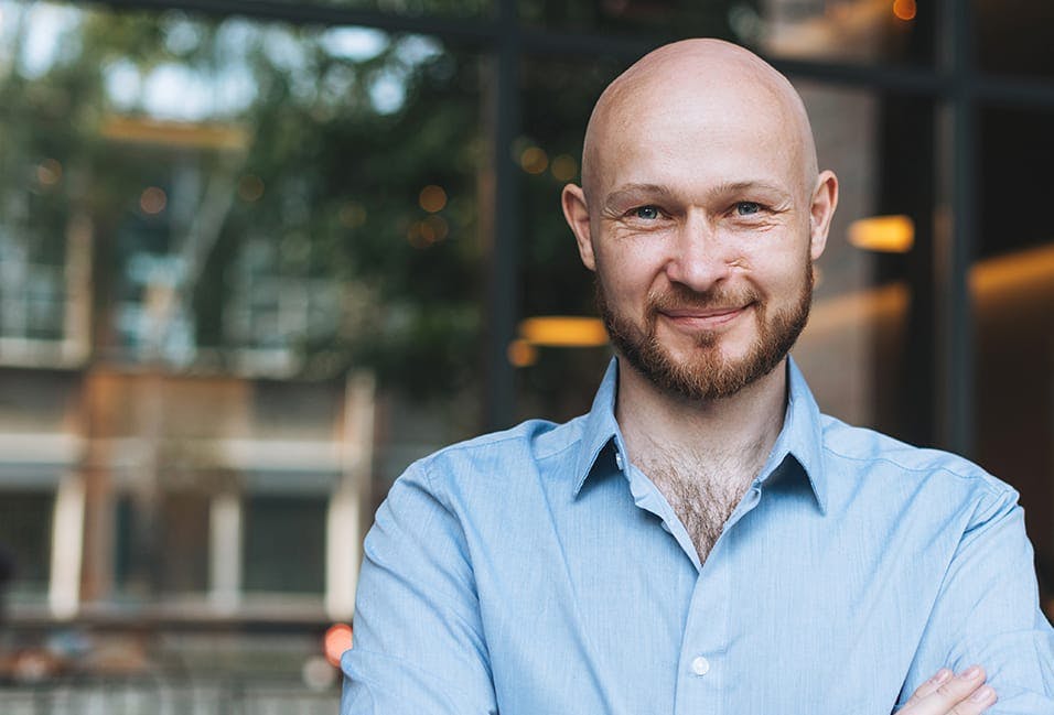 a man with a beard and a blue shirt