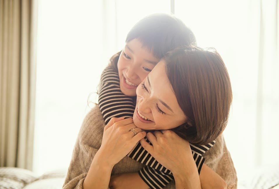 Young mother with her child on her shoulders