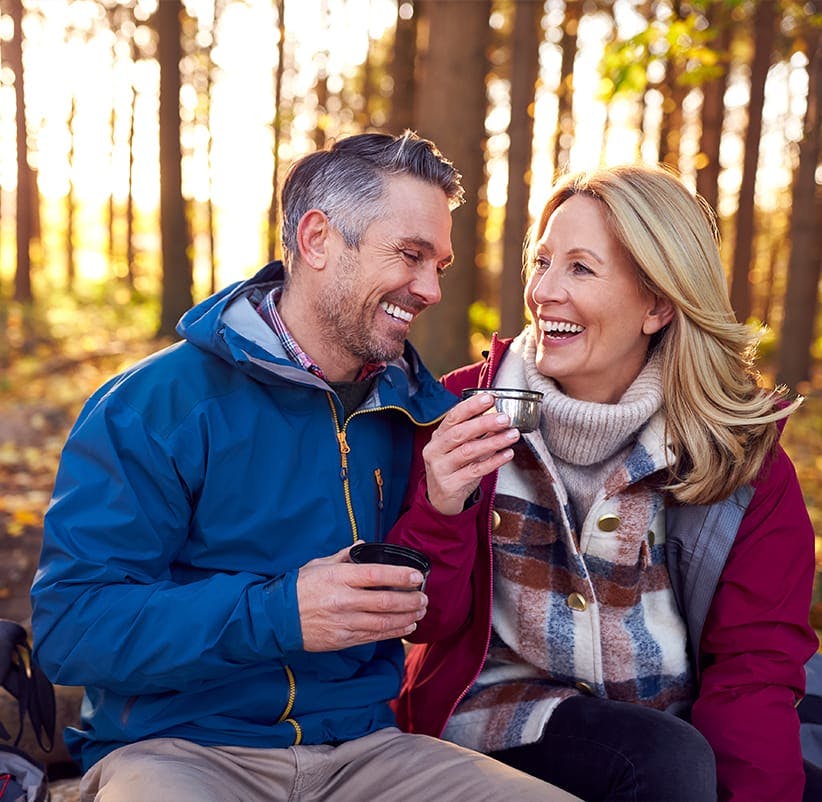 smiling couple sitting on a bench
