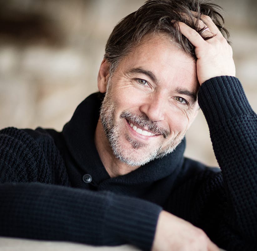 smiling man with a beard and a black sweater