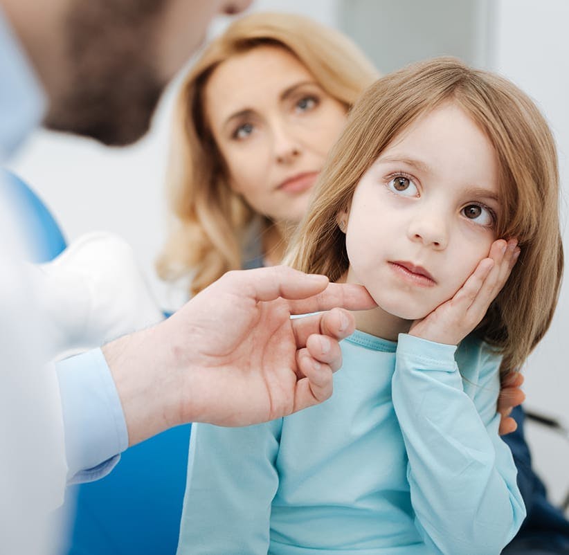 child being examined by a doctor in a hospital