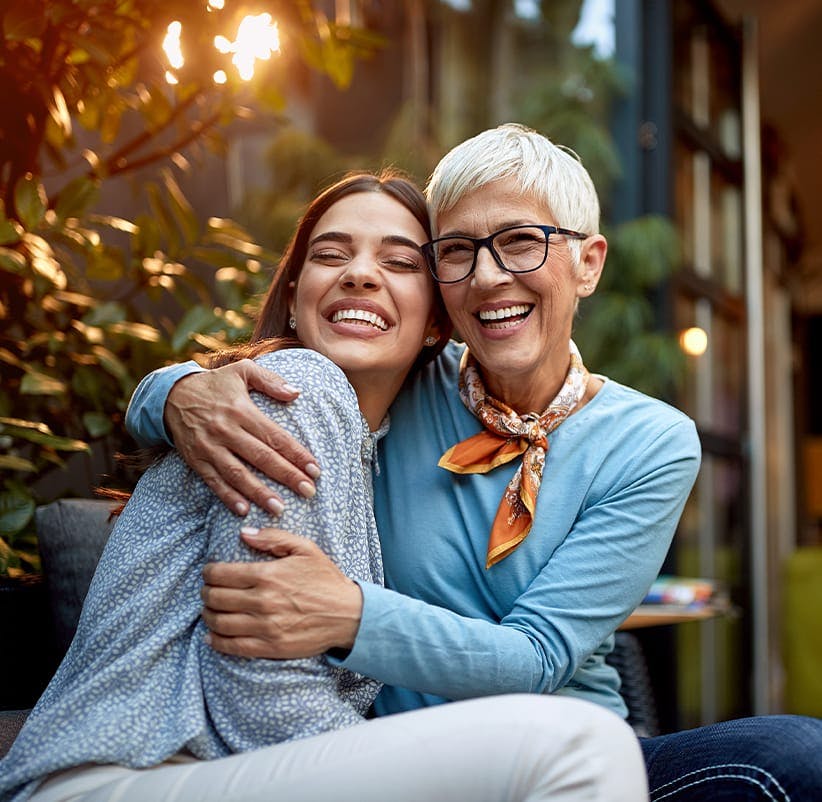 Two women hugging each other