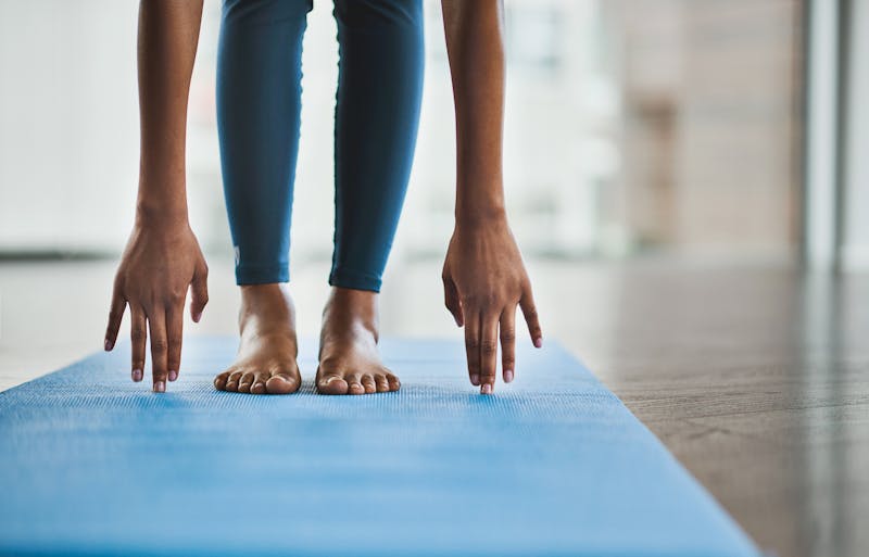 Woman stretching on yoga mat