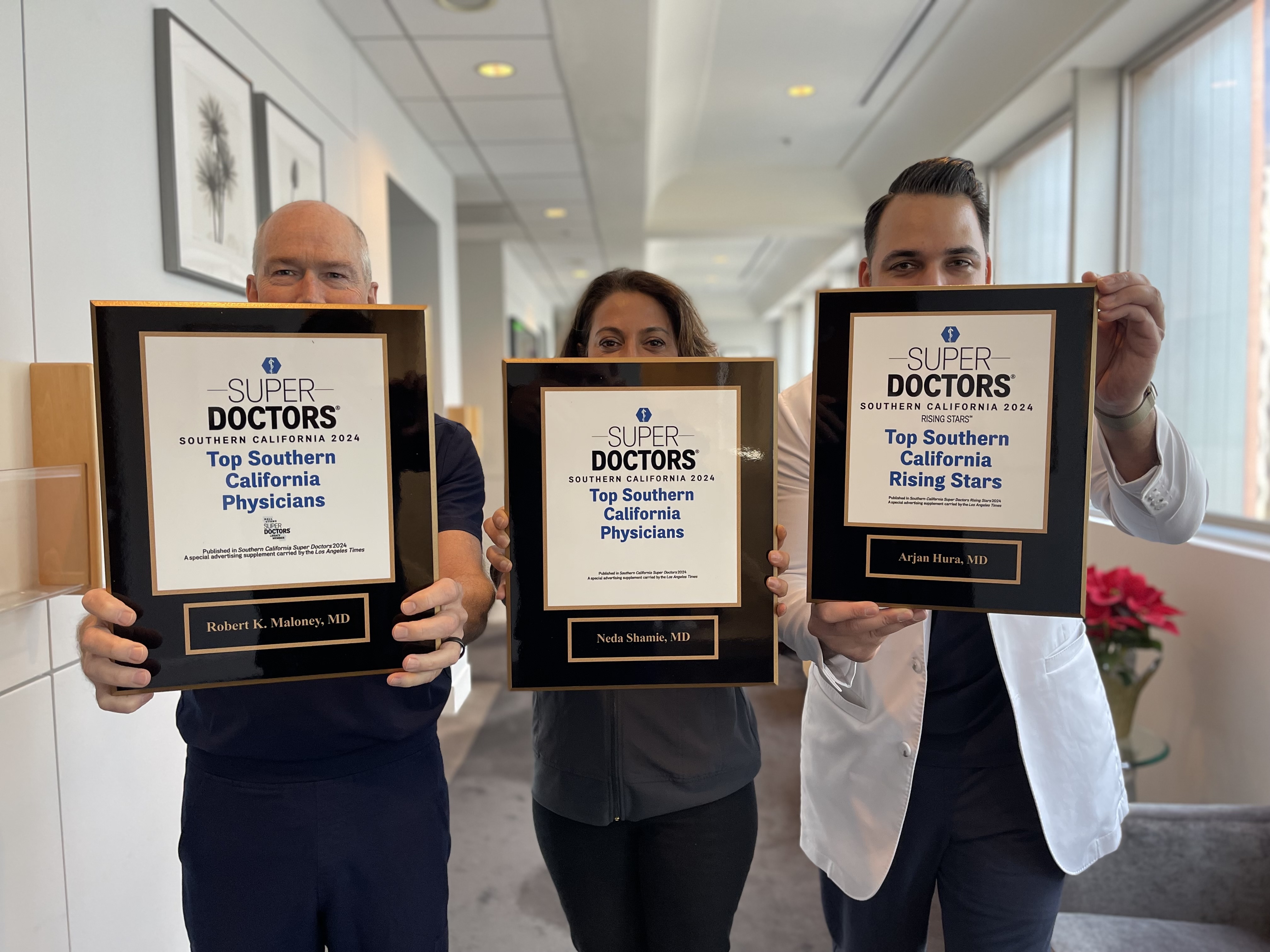 Doctors holding plaques