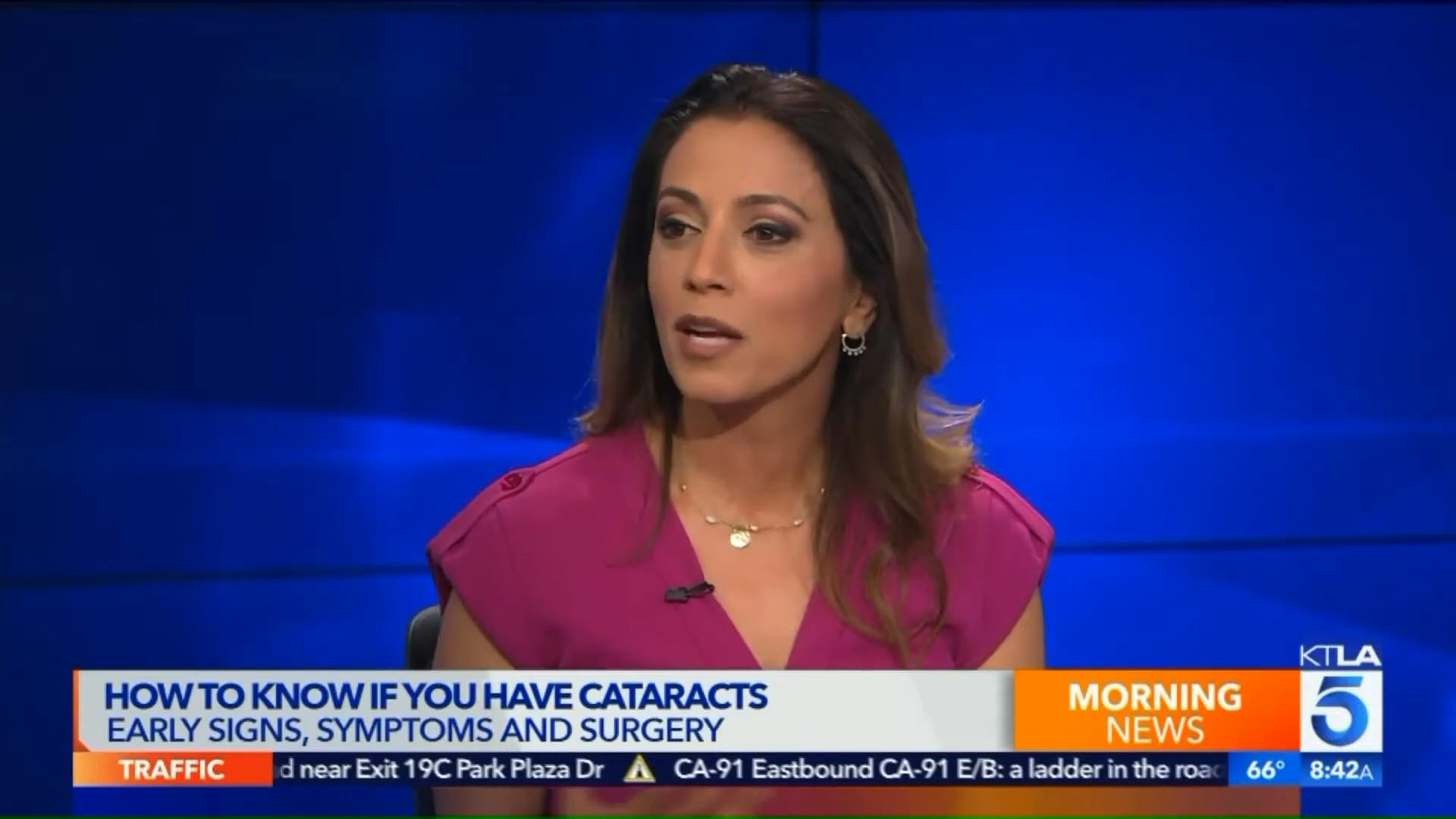 Woman in a pink shirt on the news