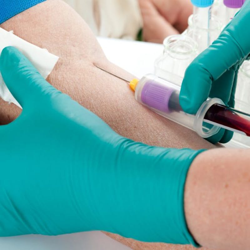 someone is getting a blood test from a doctor