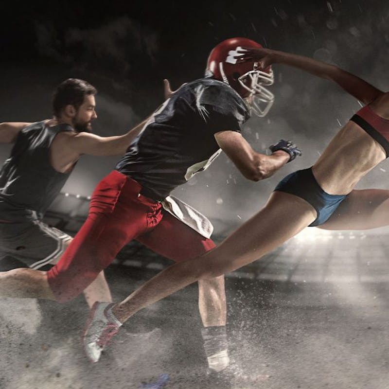 there are three people that are playing a game of football