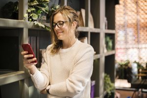 woman looking at phone at home