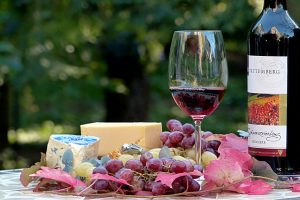 table with wine, cheese, and grapes