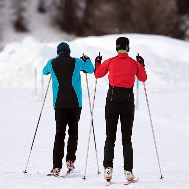 skiers are standing in the snow with their skis on