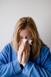 woman blowing nose 