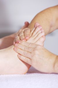 person receiving ankle and foot massage