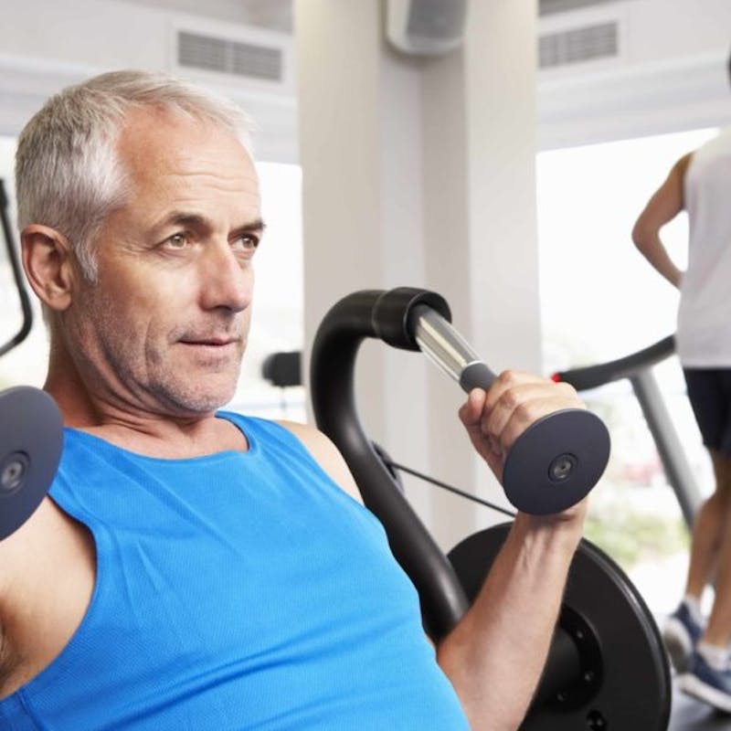 older man exercising in the gym