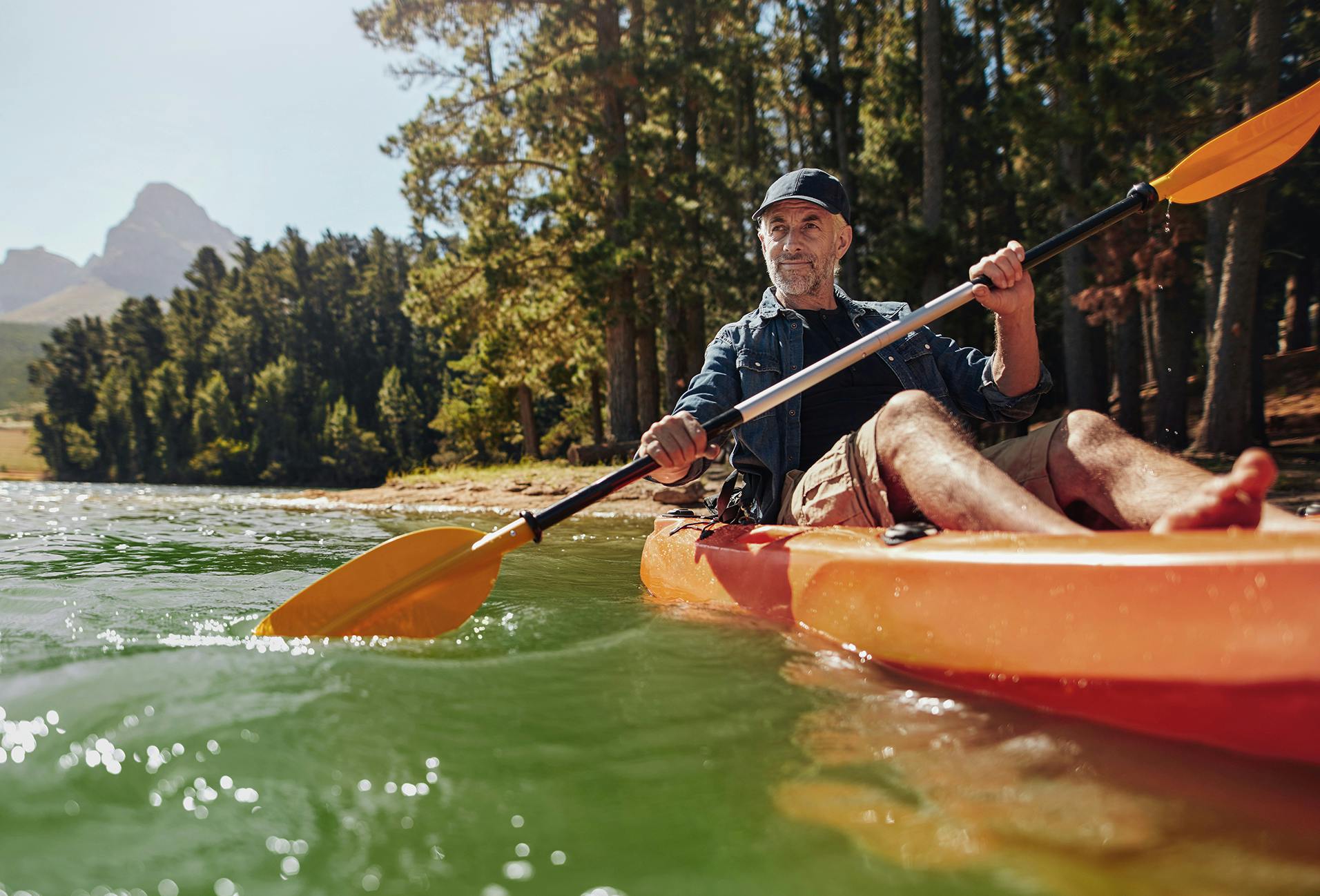 there is a man that is sitting in a kayak in the water