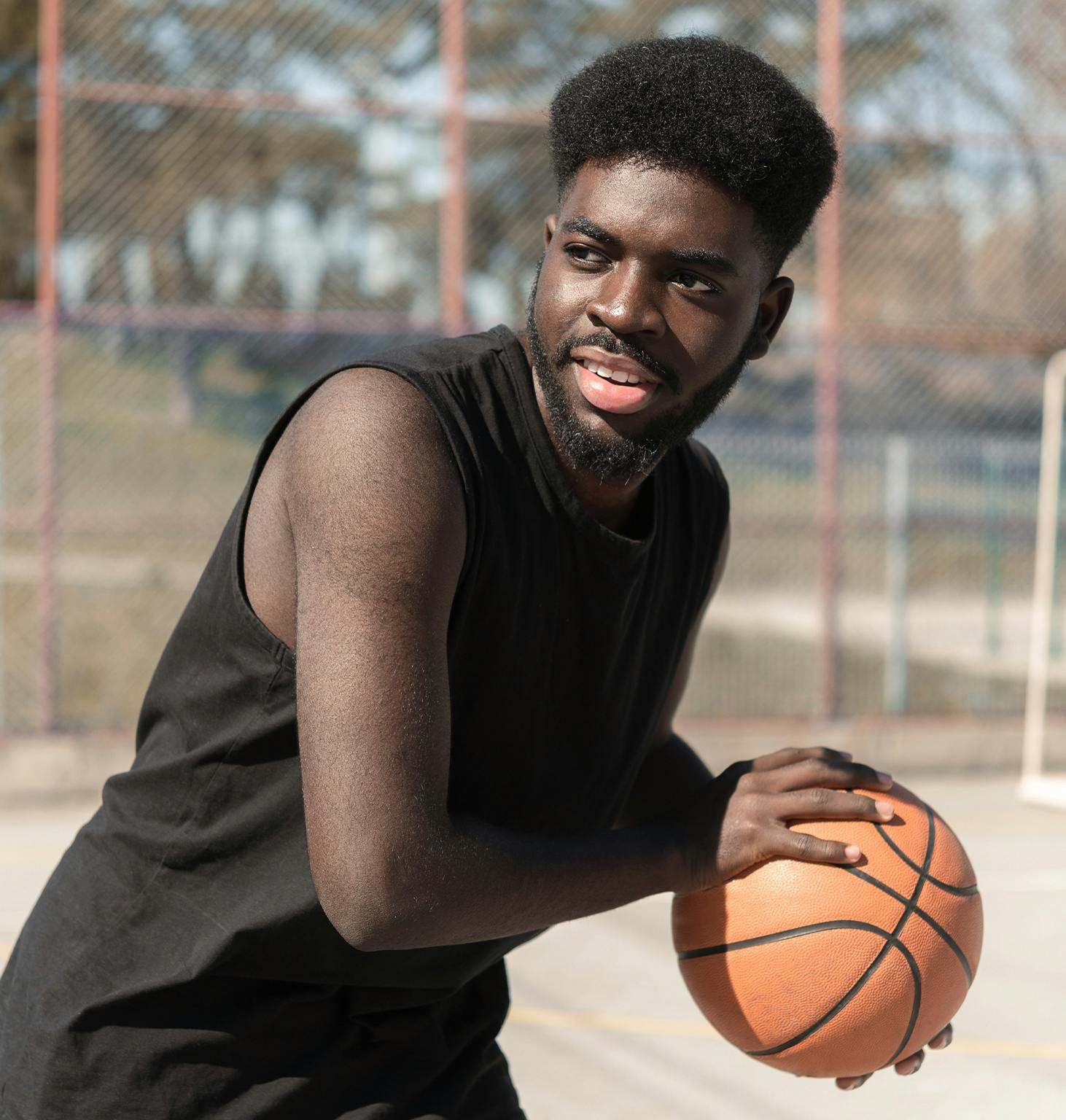 there is a man holding a basketball ball on a court