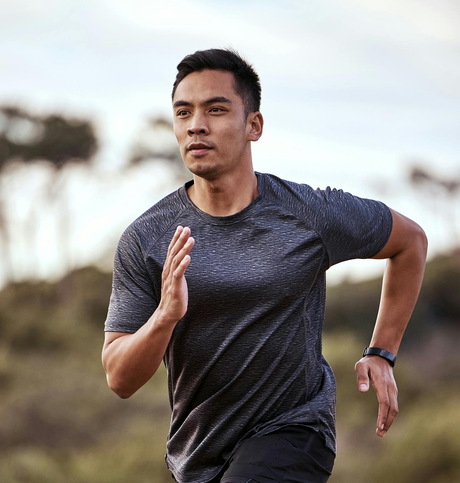there is a man running on a trail in the woods