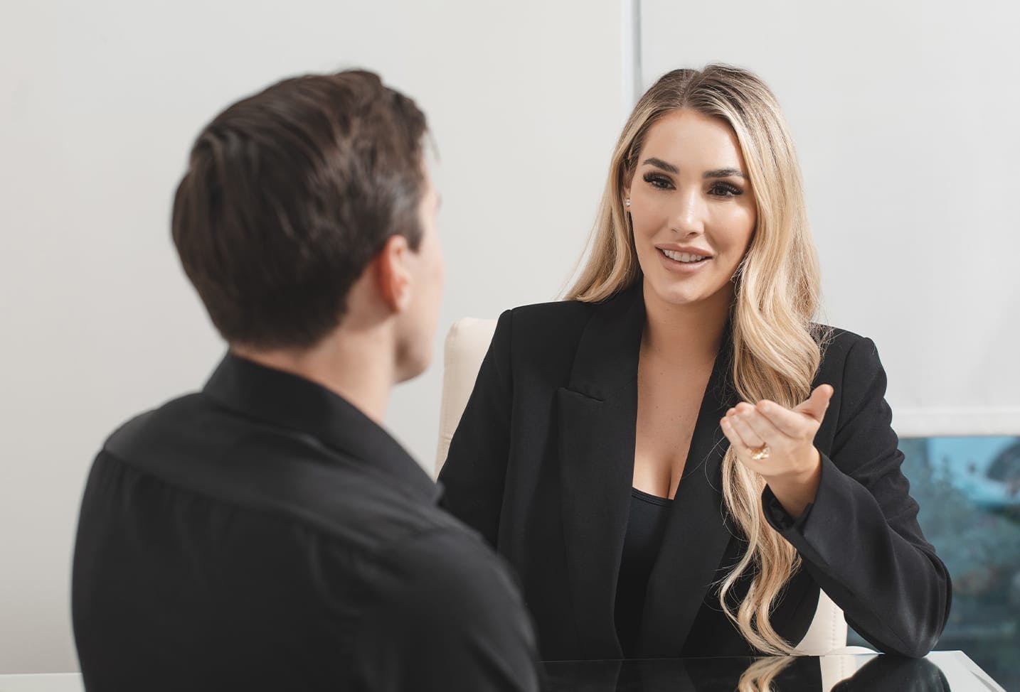 patient at the front desk talking to a staff memeber from Austin Cosmetic Surgery