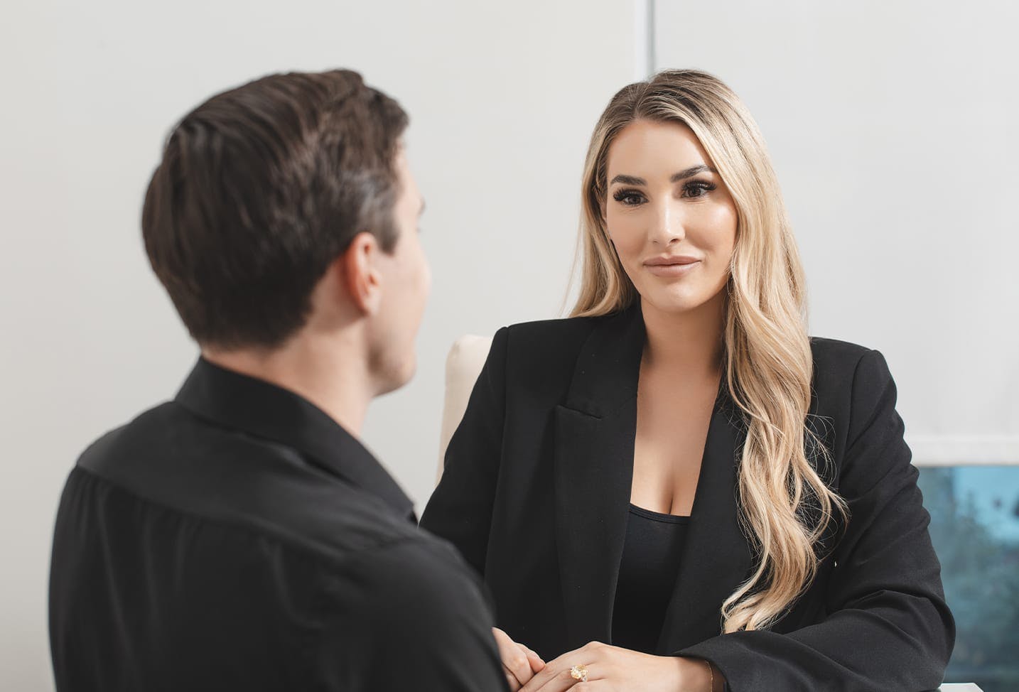 staff member at Austin Cosmetic Surgery talking with a male patient