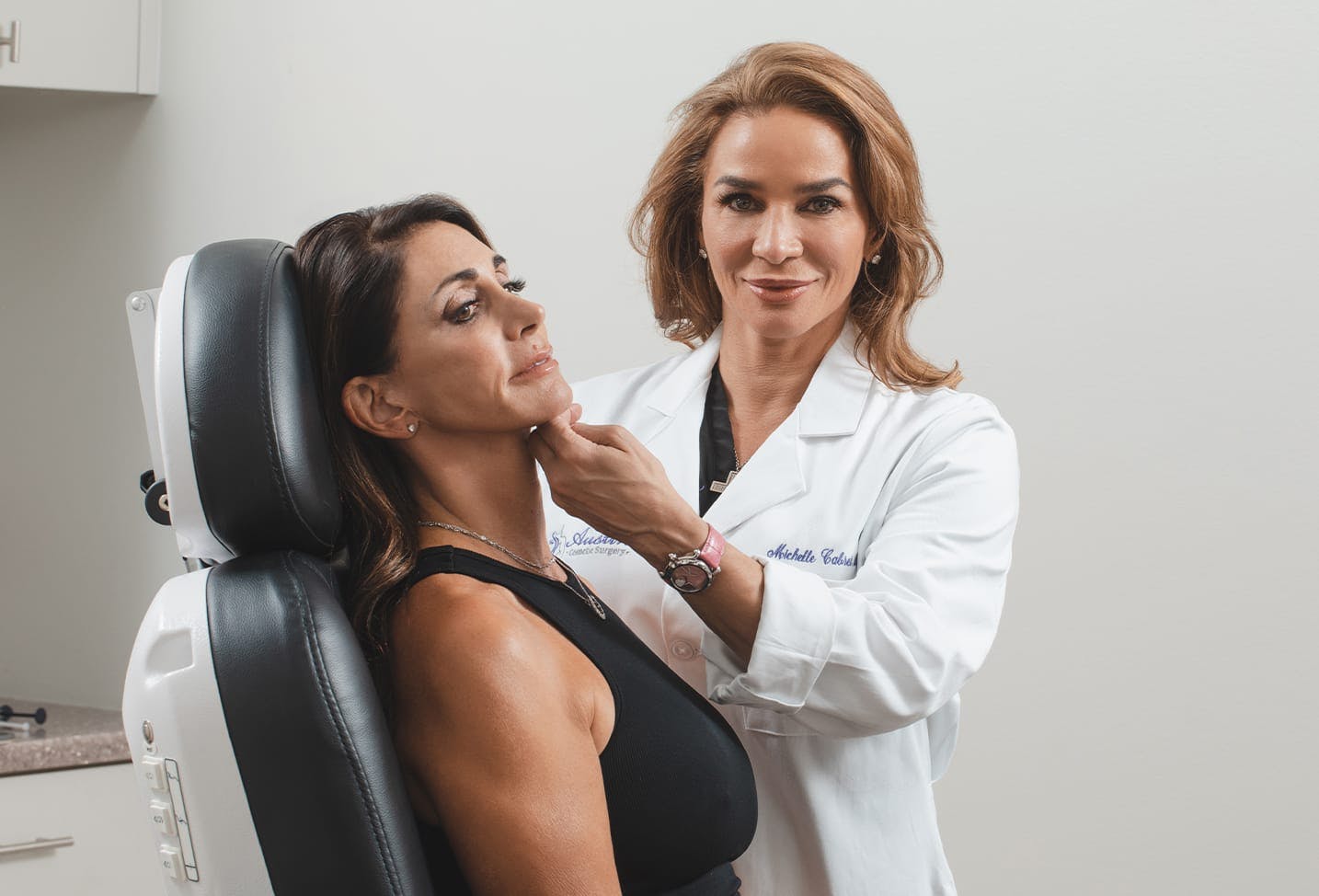 an image of Dr. Cabret conducting a facial consultation