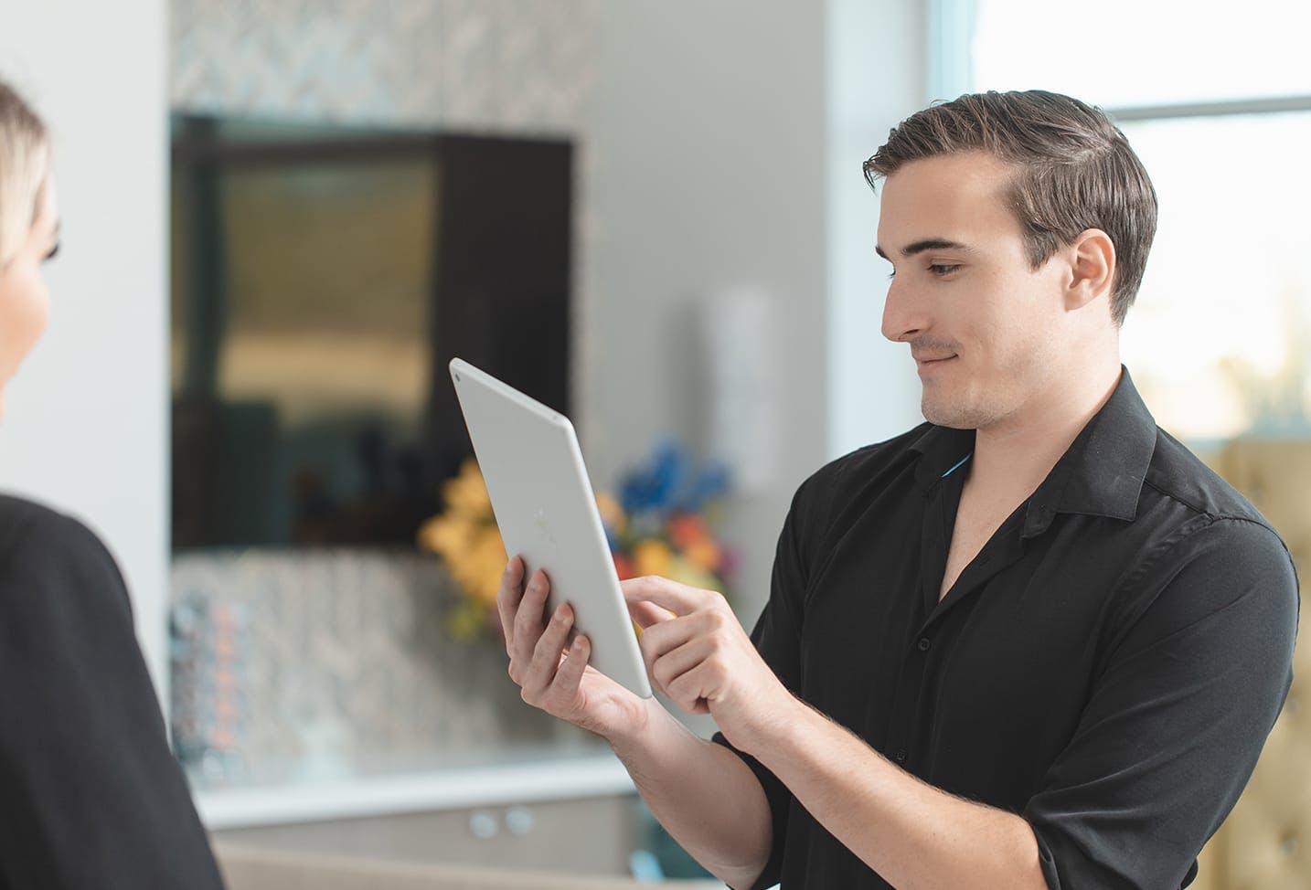 a male patient holding an ipad