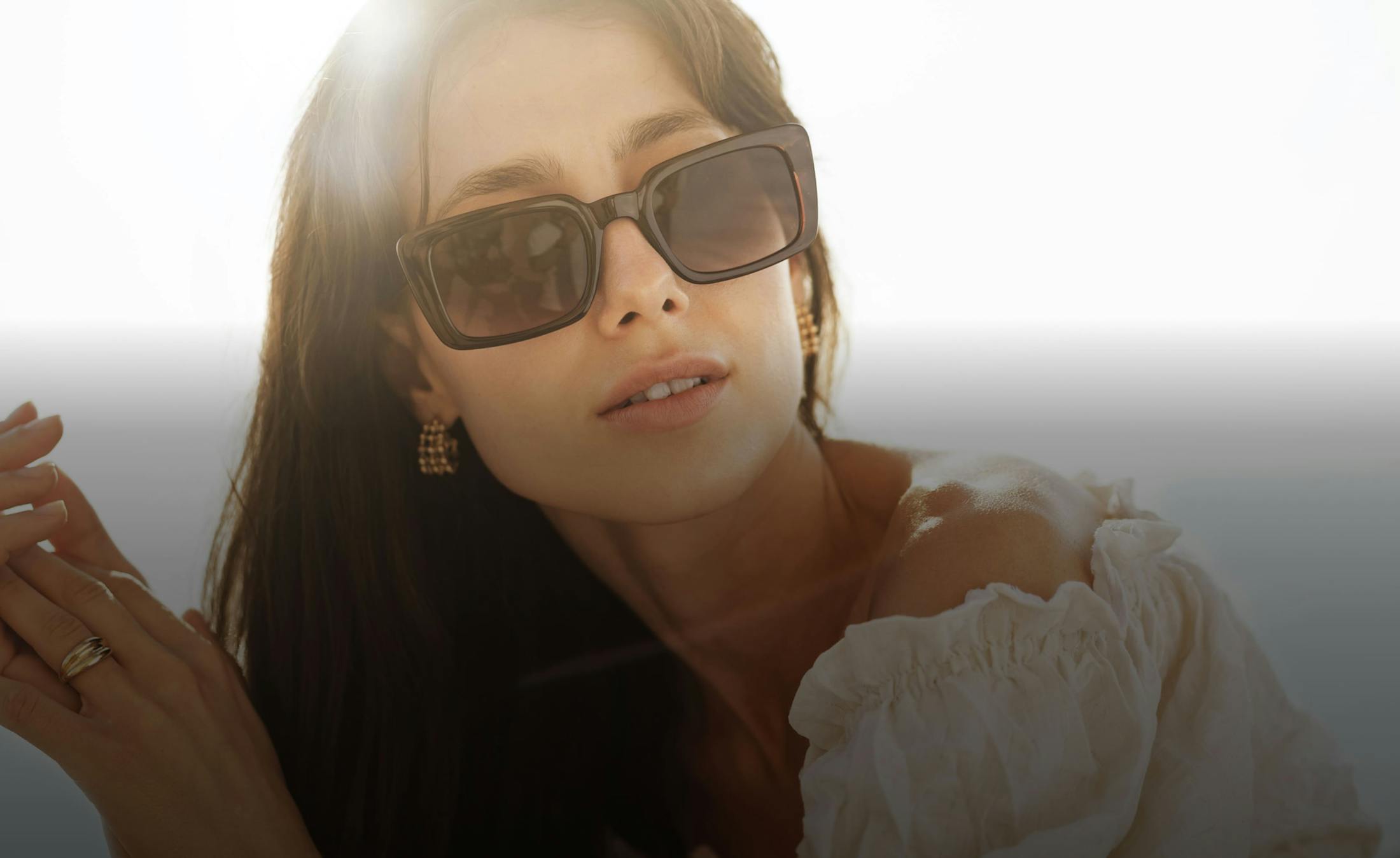 Woman in sunglasses and white blouse