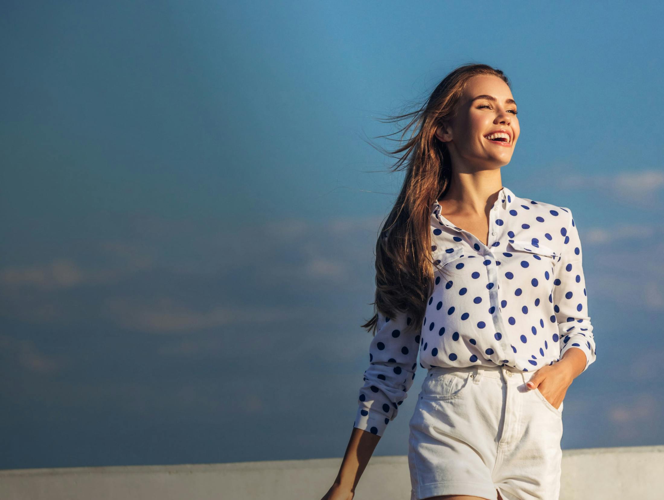 Woman laughing on the beach