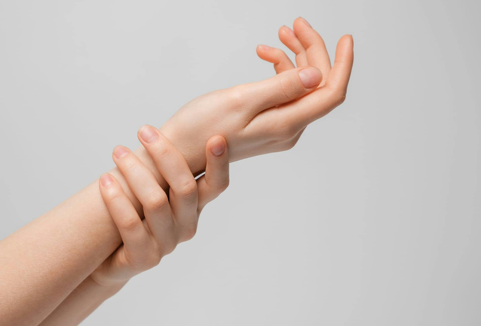 Woman holding wrists