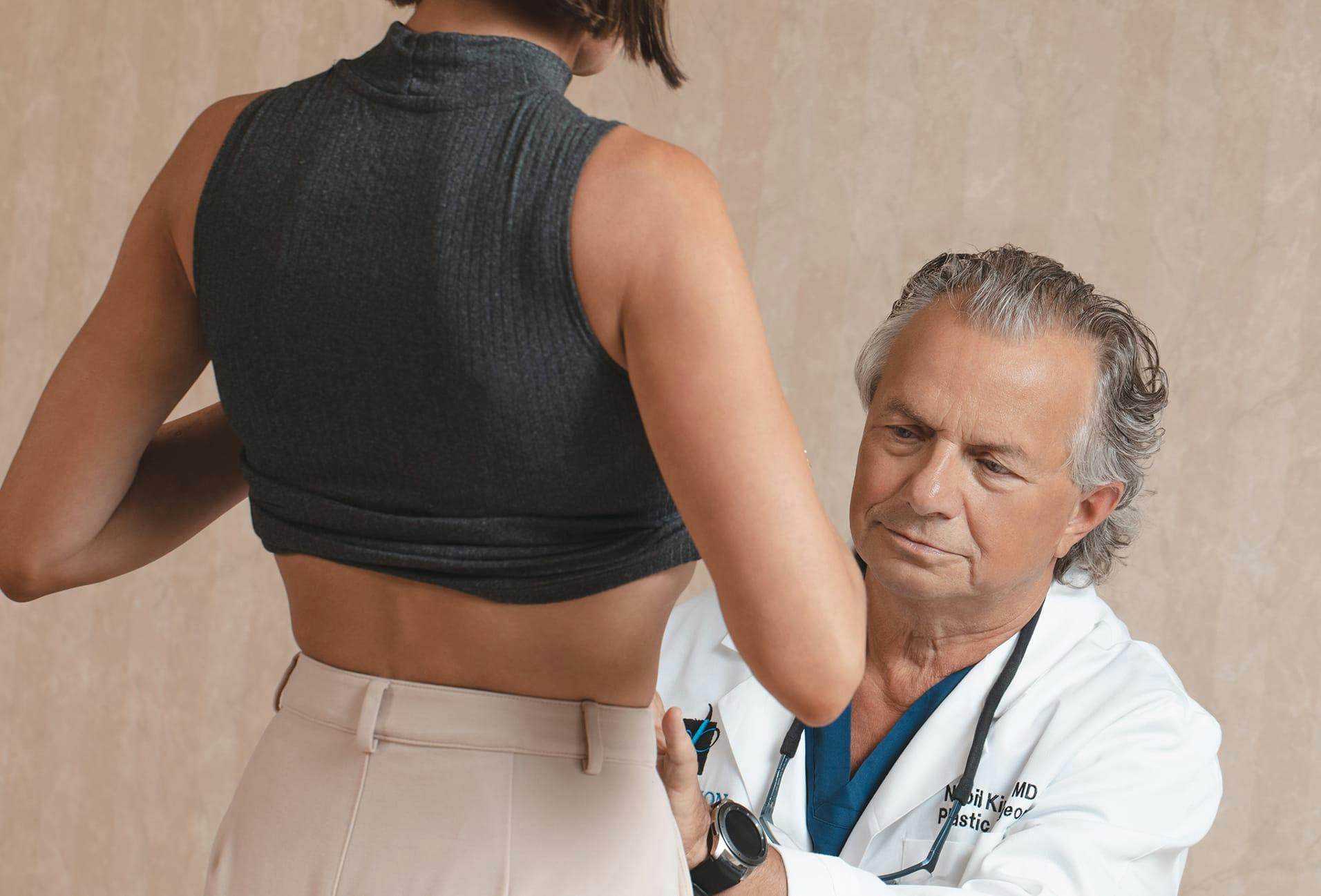 Dr. Nabil Kiridly examining patient waist