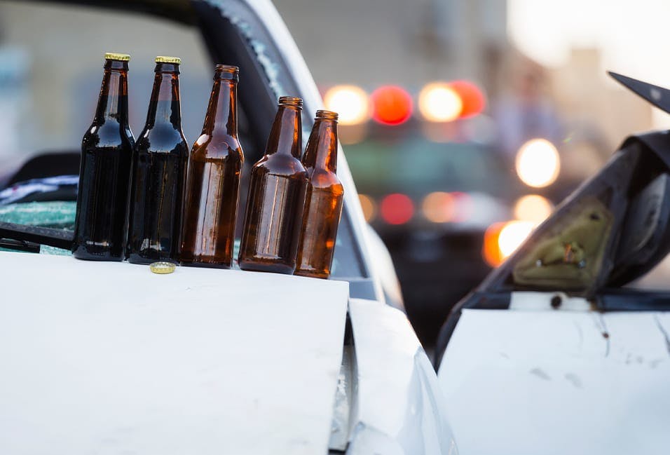 Beer bottles sitting on top of a car