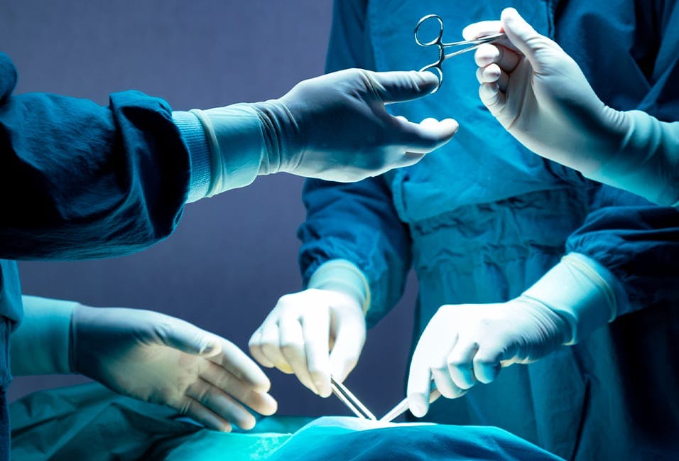 Healthcare workers preforming surgery