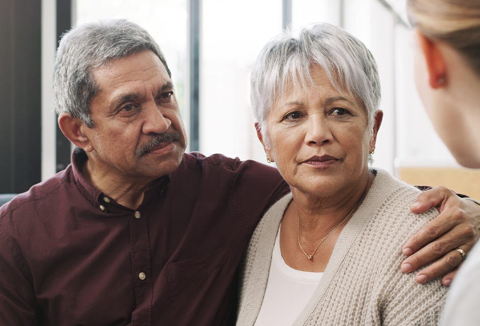 Older couple listening to woman talk