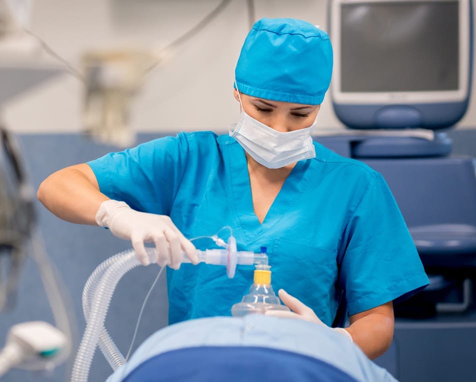 Healthcare worker providing anesthesia to patient