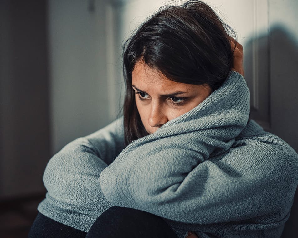 Distressed woman sitting on the floor