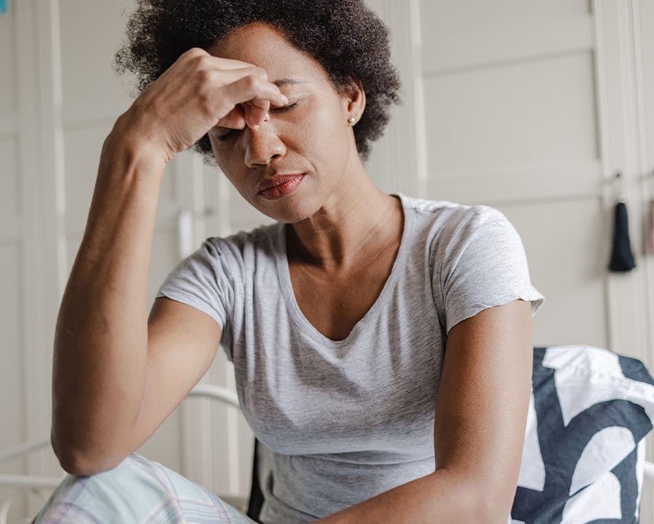 Frustrated woman resting her head on her hand
