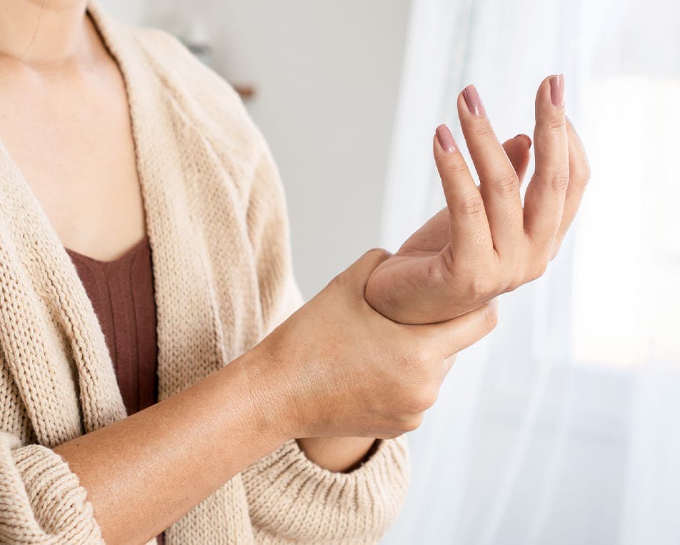 Woman holding her wrist in pain