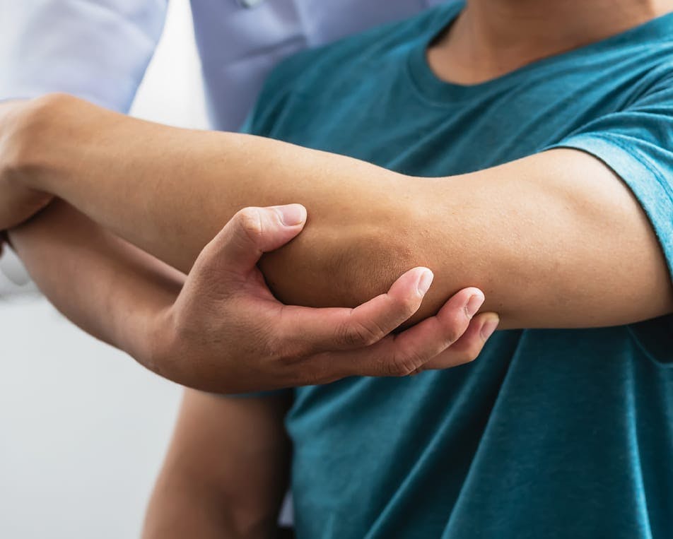 Doctor examining child's arm