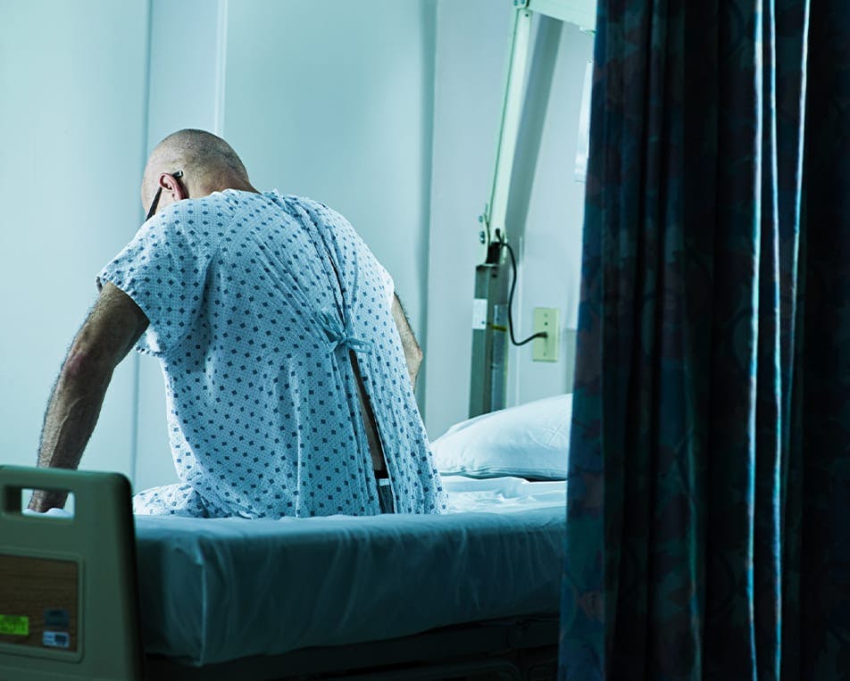 Patient sitting on hospital bed
