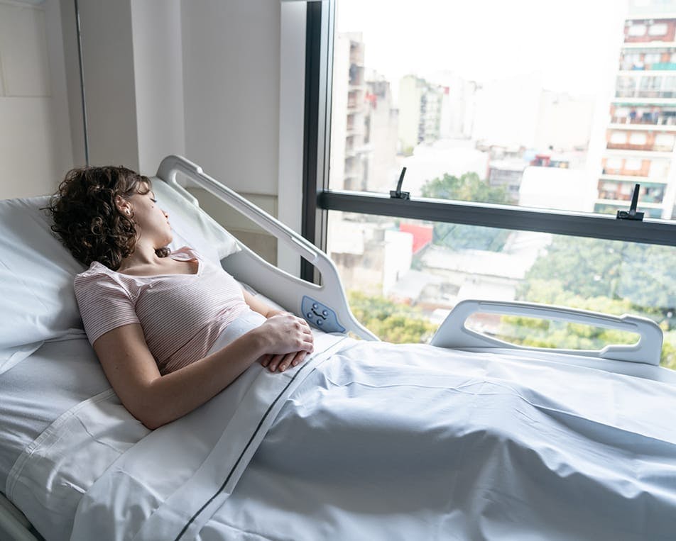 Woman lying in hospital bed